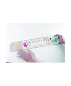 A person holding a white board with colorful paint on it.