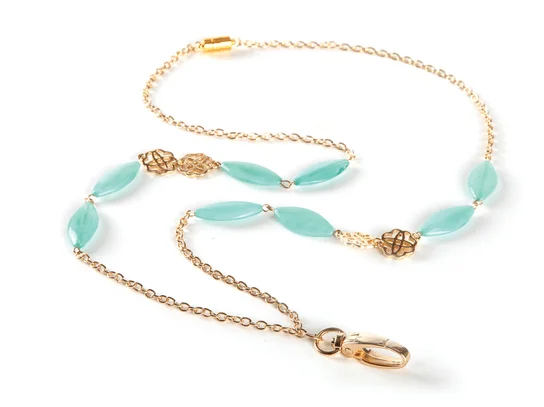 A gold chain with blue beads and a ring