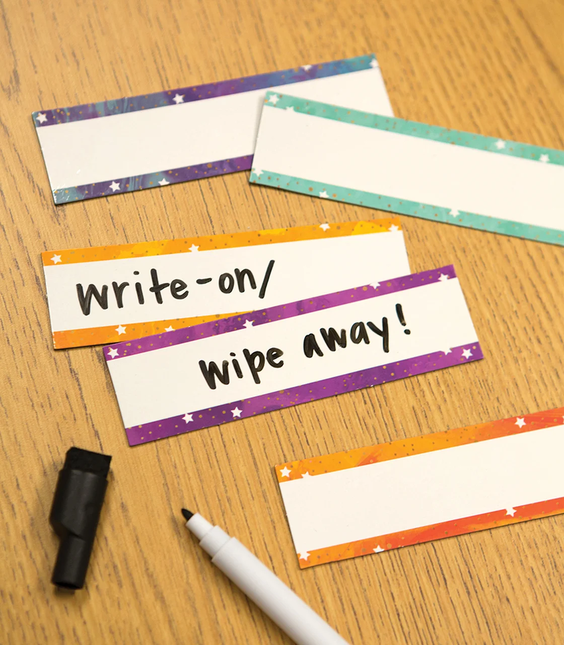 A table with four different colored paper tags.