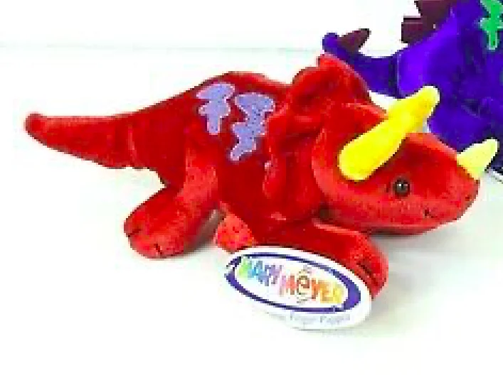 A red stuffed animal with horns and a yellow tail.