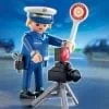 A police officer is standing next to a camera.