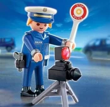A police officer is standing next to a camera.