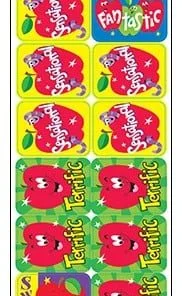 A bunch of stickers that are on the back of some apples.