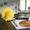 A sun shaped cookie cutter sitting on top of a table.