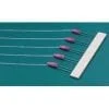 A group of six pink and white wires on top of a table.