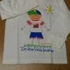 A white shirt with an image of a boy on it.