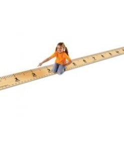 A girl sitting on the floor with a ruler