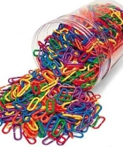 A jar of paper clips spilling over onto the floor.
