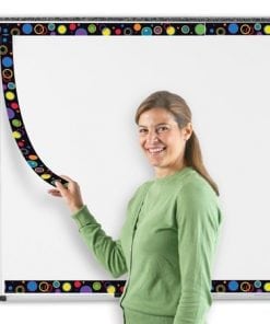 A woman is holding a board with a colorful border around it.