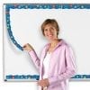 A woman holding onto a ruler in front of a whiteboard
