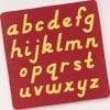 A red and yellow alphabet mat with letters in it.