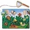 A wooden puzzle with bugs and insects on it.