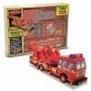 A toy fire truck in its box with the lid open.