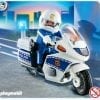 A playmobil police officer on a motorcycle.