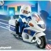 A playmobil police officer on a motorcycle.