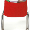 A red chair with a book pocket on the back.