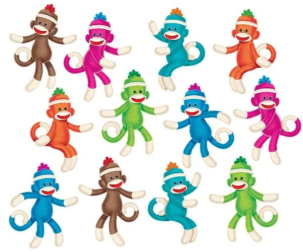 A group of colorful monkeys wearing hats and scarves.