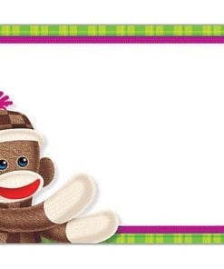 A monkey sitting on top of a green and white background.