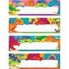 A set of four colorful dinosaur themed name plates.