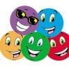 A group of six different colored smiles with one smiling.