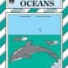 A book cover with dolphins swimming in the ocean.
