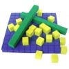 A green and yellow object sitting on top of some purple blocks.