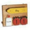 A wooden calendar with apples and milk.