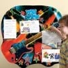 A young boy is playing with his guitar.