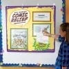 A girl is pointing to the comic relief poster.