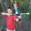 A boy holding a toy bow and arrow.