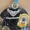 A black jacket with white trim and a blue hat.