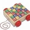 A wooden block cart with letters and numbers.
