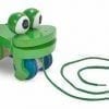A green toy frog with eyes and mouth.