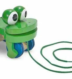 A green toy frog with eyes and mouth.