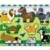 A wooden puzzle of animals in the grass.