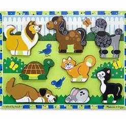 A wooden puzzle of animals in the grass.