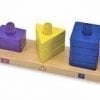 A wooden board with three different colored blocks on it.