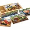 A wooden box with four puzzles on it.