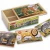 A wooden box with four different animal puzzles.