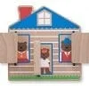 A wooden house with three bears inside of it.