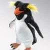 A stuffed penguin with yellow hair and black body.