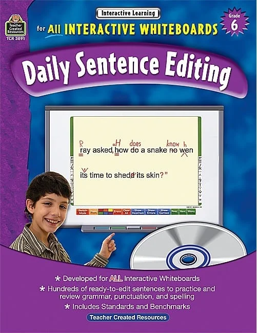 A boy is holding a dvd and writing on the screen.