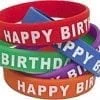 A stack of happy birthday bracelets in different colors.