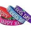 A group of happy 1 0 0 th day wristbands.