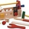 A wooden toy tool set with tools and accessories.